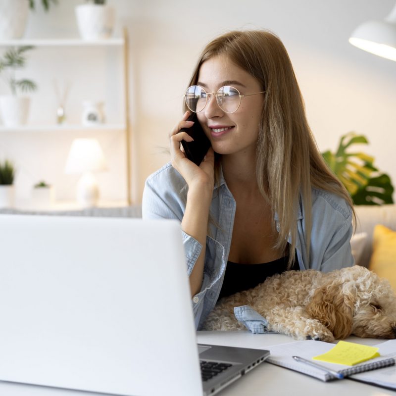 medium-shot-woman-working-with-dog-home